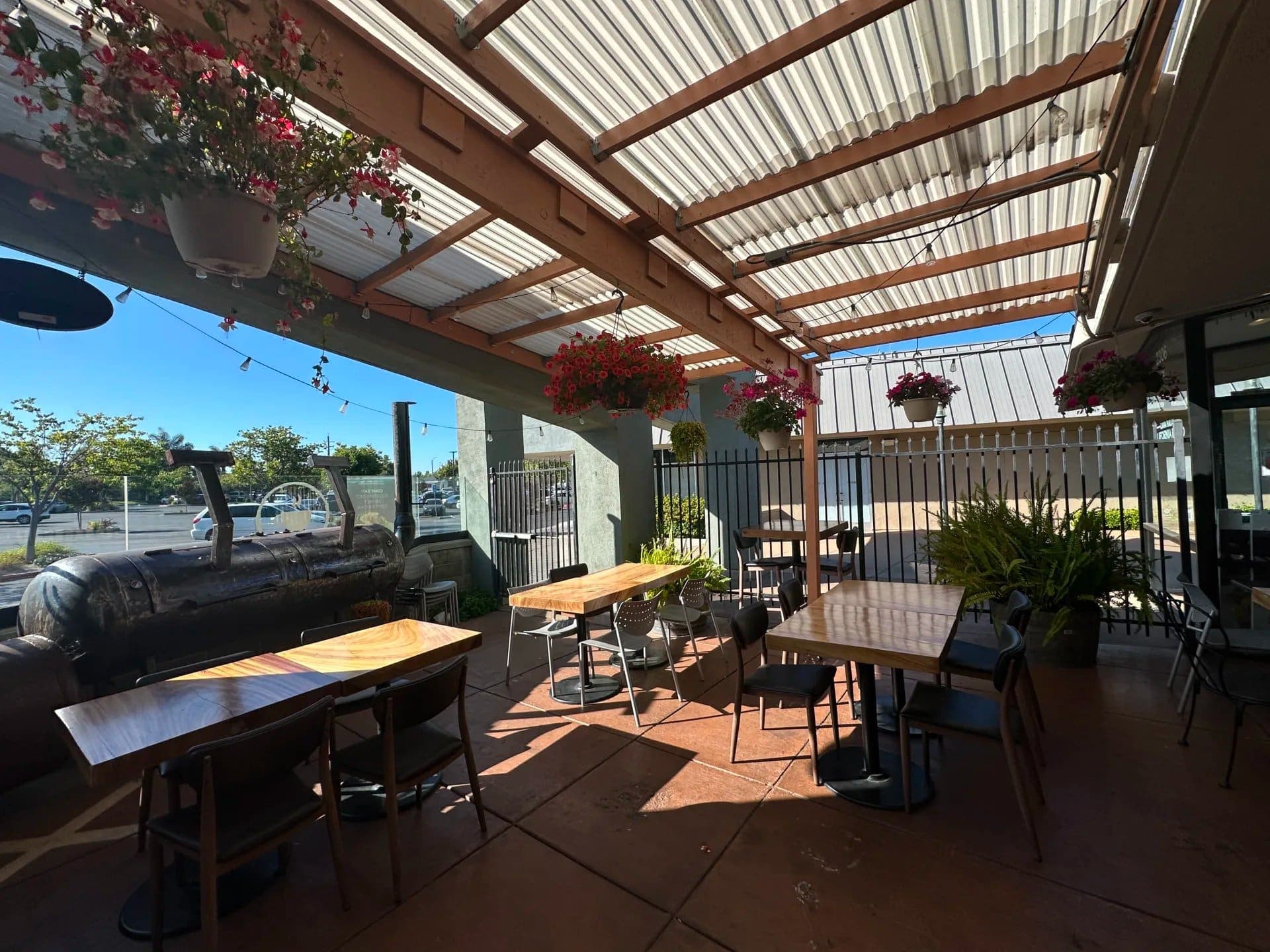 Covered outdoor patio with hanging flowers at iJava Cafe Willow Glen