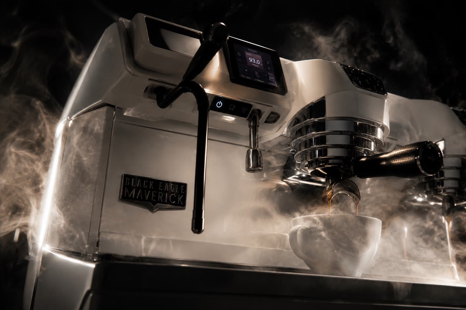 A white Victoria Arduino Black Eagle Maverick espresso machine pulling a shot, steam rising, the Black Eagle Maverick badge on its side.
