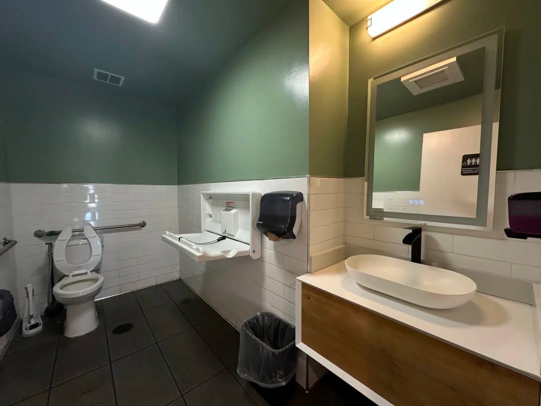 Modern ADA-accessible restroom with changing table